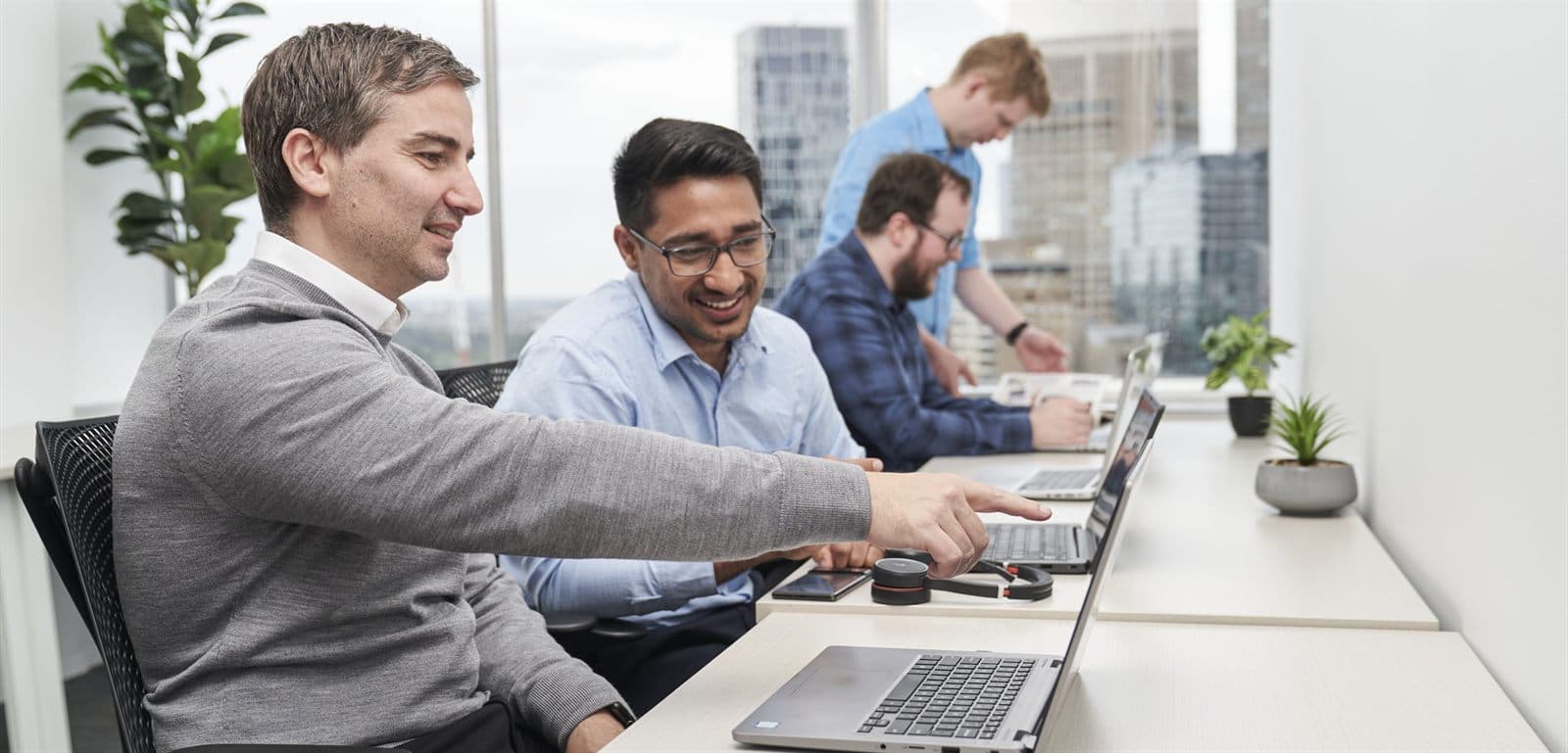 Two of the Intuitive IT team going through a report on a laptop