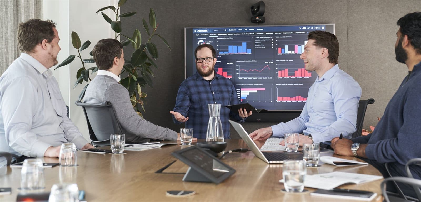 The Intuitive IT team reviewing reporting dashboards in the boardroom