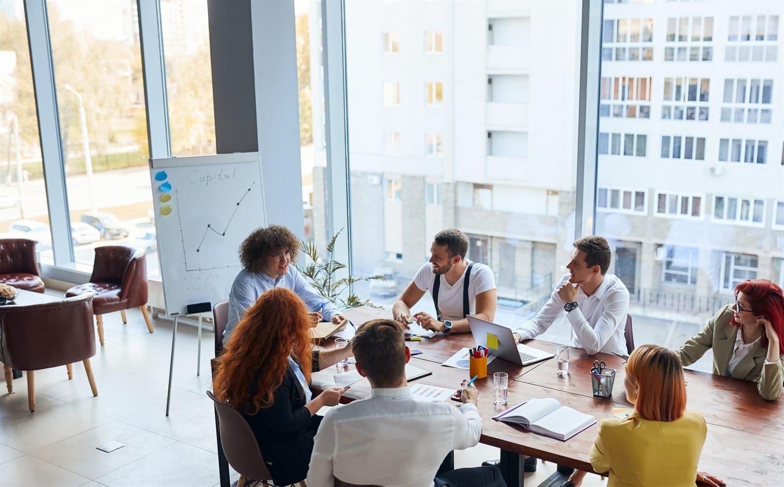 A hiring panel talking around a meeting room table